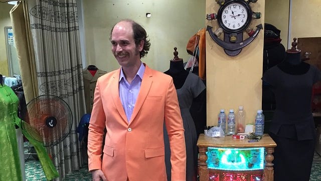 Chef Tandy Wilson gets fitted for a suit that declares his love for the Tennessee Volunteers.