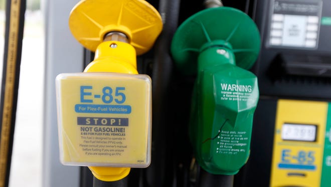 In this Aug. 9, 2014, file photo, a fuel nozzle for E-85, left, and traditional gasoline is seen at a gas station in Batesville, Miss. The Obama administration is boosting the amount of corn-based ethanol and other renewable fuels in the U.S. gasoline supply. That's despite sustained opposition by an unusual alliance of oil companies, environmentalists and some GOP presidential candidates.