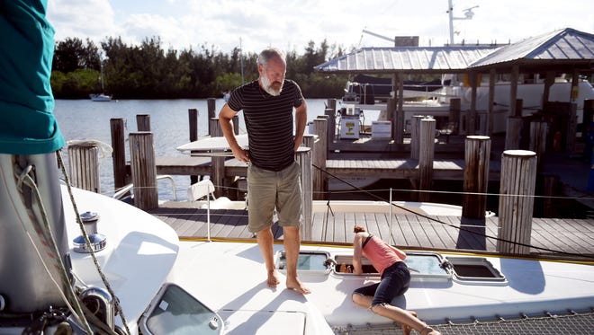 Santee Remaily walks the deck of his 41-foot catamaran sailboat as his children play around him at the Vero Beach Municipal Marina on Tuesday, May 1, 2018. Remaily, along with his wife, Krista, five children and a son-in-law sailed the boat from Maryland and arrived in Vero Beach in February. "We picked Vero Beach because it's an ideal spot to have a sailboat in Florida during hurricane season," said Krista Remaily. "And once we were here we realized that the community was wonderful to have a family with lots of children." The city is considering leasing out the marina to a private company and is soliciting proposals from eight companies experienced in managing city-owned marinas. "We would love it if it stays the way it is because we are considering coming back next summer," Remaily added.