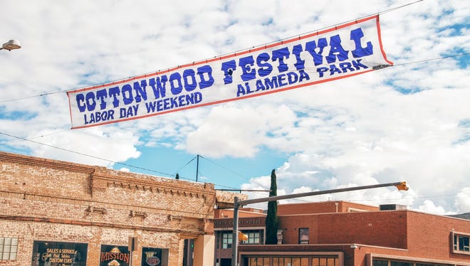 A Cottonwood Festival sign hangs over 10th Street. The community event begins today through Sunday, Sept. 4.