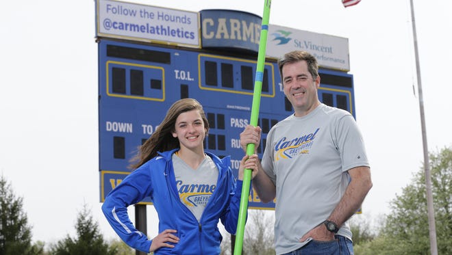 Carmel High School pole vaulter, Kara Deady and her father Mark Deady pose for a photo at C.H.S. in Ind. on Friday, May 4, 2018. Mark Deady competed in the 1500 meter race during the 1988 Olympic Games in Soul South Korea while Kara's mother, Dawn Gelon earned the sixth-best Heptathlon score in Indiana University history.