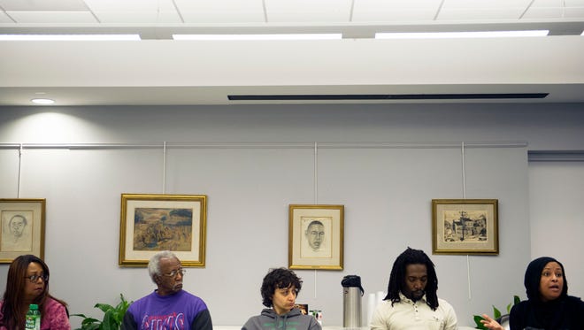 Members of the community listen as Shannon Harper-Jenkins, far right, voices her concerns during a meeting regarding school zone redistricting at the Beck Cultural Exchange Center on Saturday, Feb. 11, 2017