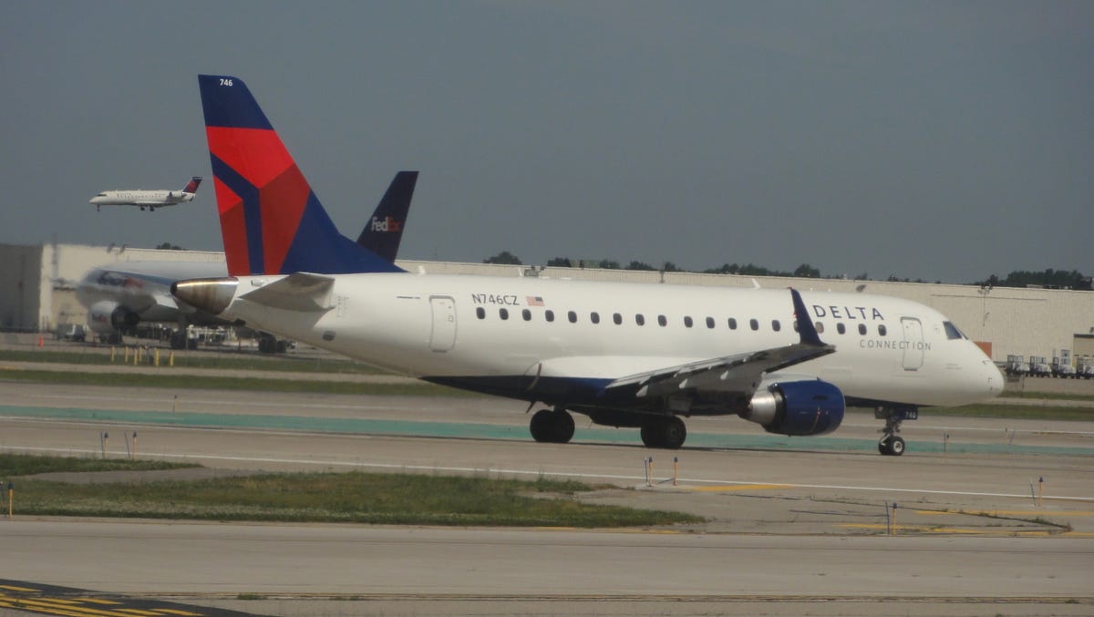 A Delta Connection Embraer E170 jet is seen taxiing at Detroit Metro Airport on June 30, 2011. The plane belongs to Delta Connection affiliate Compass Airlines, which flies regional flights for Delta Air Lines.