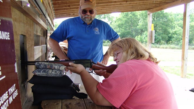 Bill Balda, hunter education supervisor for the Kentucky Department of Fish and Wildlife Resources, instructs Tia Edwards, information specialist for Kentucky Fish and Wildlife, on proper rifle shooting techniques at the Kleber Wildlife Management Area rifle range in Owen County.