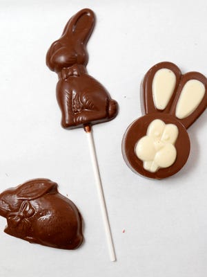 Salted caramel bunnies (clockwise, from left), solid chocolate lollipops and chocolate-covered Oreo cookies are among the milk chocolate treats popular this time of year at Beaverdale Confection Co. in Des Moines.