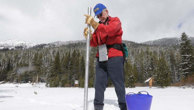 Frank Gehrke, chief of California Cooperative Snow Surveys Program for the Department of Water Resources plunges the snow depth survey pole into the snowpack he conducts the snow survey near Echo Summit, Calif., Tuesday, March 3,  2015.