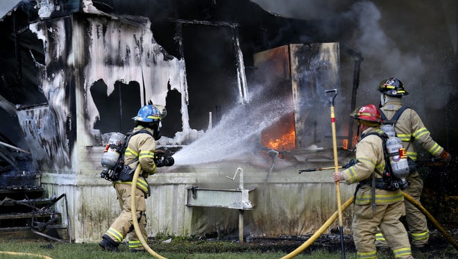 Firefighters respond to a fire at a vacant mobile home in August.
