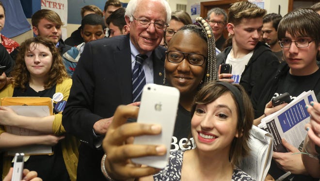 Vermont Sen. Bernie Sanders poses for a selfie with supporters at his campaign office on Dec. 13, 2015, in Waterloo, Iowa.