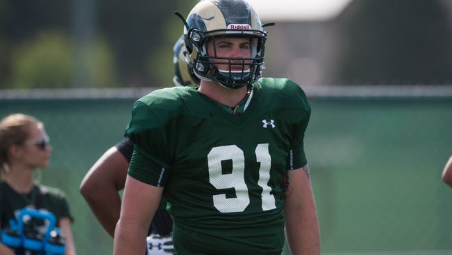 Defensive lineman Jakob Buys listens to instructions before the start of a drill in an Aug. 10 practice with the CSU football team. Buys, a walk-on the past three seasons, was awarded a scholarship for the 2015-16 school year by coach Mike Bobo.