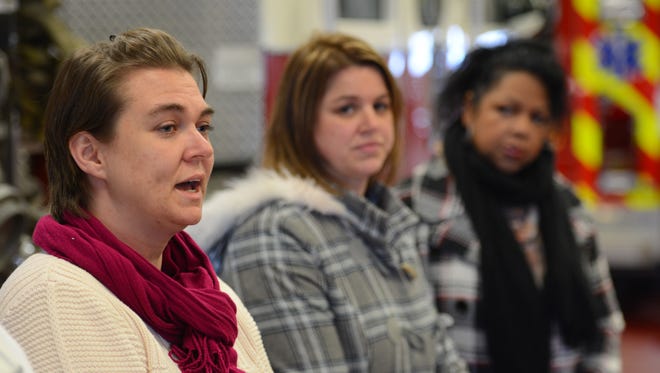 Howe Community Resource Center coordinator Valerie George, left, talks about the need for blankets during the Blanketing Brown County press conference to announce the results of the 2014 blanket drive.