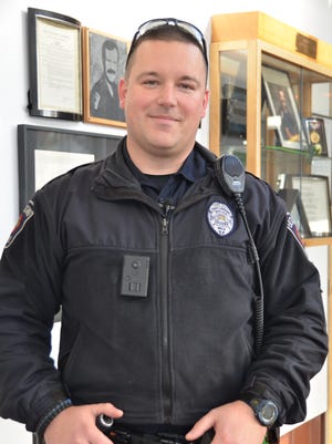East Lansing police officer Scott Klavenski wears one of the department's body cameras.