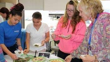 (l-r) Health Occupations students Megan Flores of Bound Brook, Margaret Moret of North Plainfield, and Amber Catlin of Bridgewater, along with instructor Kim Vasaturo try some food samples.