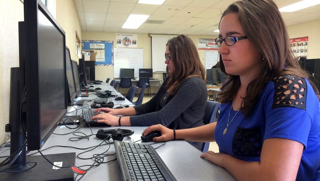 Leticia Fonseca, 16, left, and her twin sister, Sylvia Fonseca, right, work in the computer lab at Cuyama Valley High School after taking the new Common Core-aligned standardized tests, in New Cuyama, Calif., on April 30, 2015. 