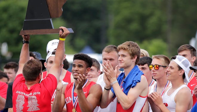 Kimberly lifts their Division 1 championship trophy after the finals of the WIAA state track and field meet Saturday, June 2, 2018, at Veterans Memorial Stadium in La Crosse, Wis.