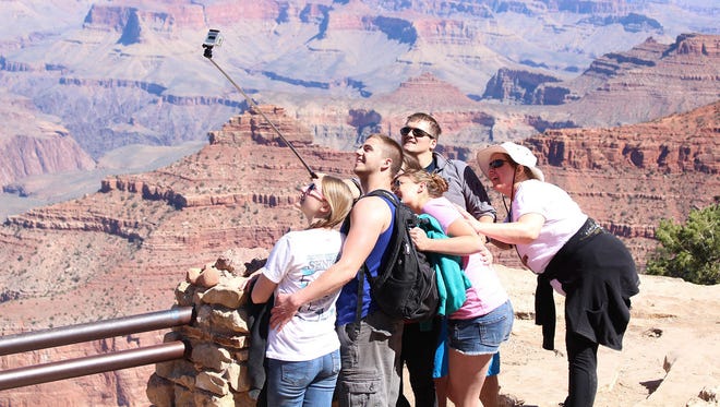 Tourists pose for a selfie in Grand Canyon National Park.