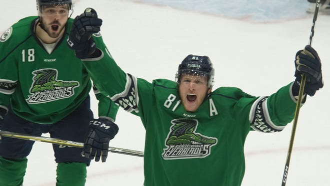 Everblades forward Stephen MacAulay (81) and forward Spencer Smallman cheer following their team's first goal against the Adirondack Thunder during Game 4 of the Eastern Conference Finals. The Blades, who beat Adirondack 4-1 in their series, will open Kelly Cup Finals play on Friday at Colorado.