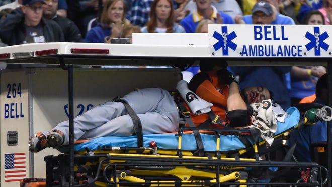 Marlins right fielder Giancarlo Stanton is carted off the field after getting hit by a pitch in the fifth inning against the Milwaukee Brewers at Miller Park. Mandatory Credit: Benny Sieu-USA TODAY Sports