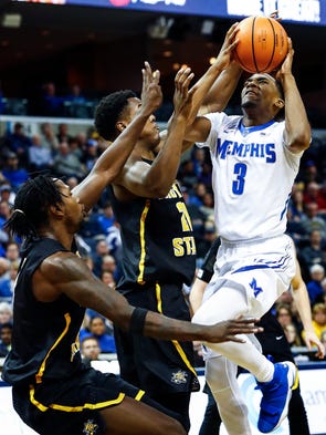 Memphis guard Jeremiah Martin (right) drives the lane