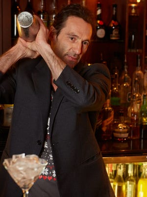 Ray Harvey mixes up one of his signature cocktails at Ace Gilletts.