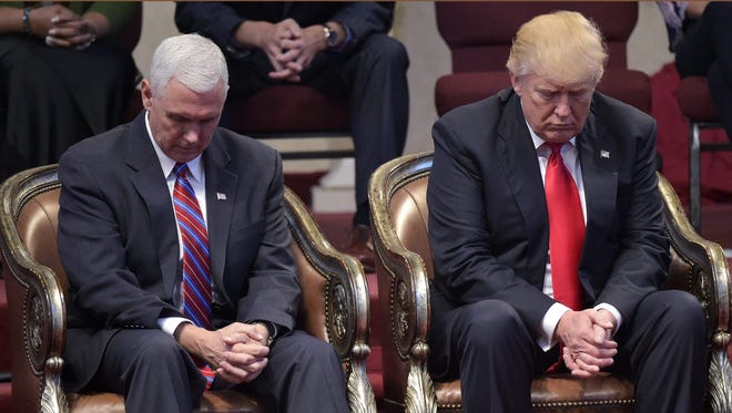 Donald Trump and Mike Pence pray in Cleveland Heights, Ohio, on Sept. 21, 2016.