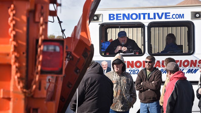 Auctioneer Tim Benoit collects bids on a truck Saturday during the Stearns County fall seized and surplus auction.