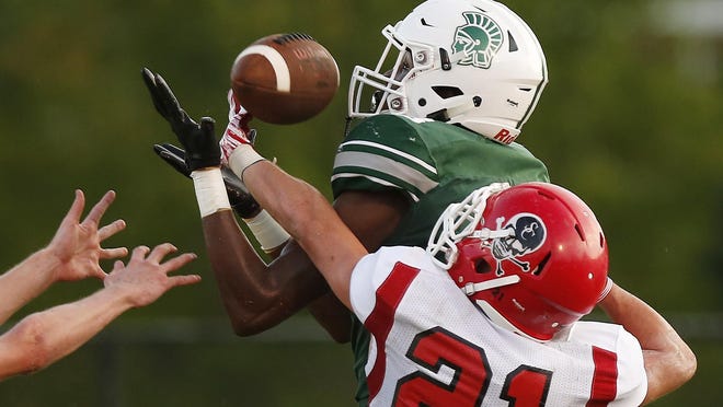 Athens Academy's Deion Colzie brings in a pass for a touchdown while being defended by Savannah Christian's Blake Brown during a GHSA high school football game between Athens Academy and Savannah Christian.