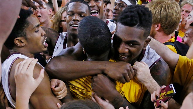 The Arizona State Sun Devils celebrate their 81-78 win over the Arizona Wildcats in their NCAA basketball game on Feb. 7, 2015, in Tempe.