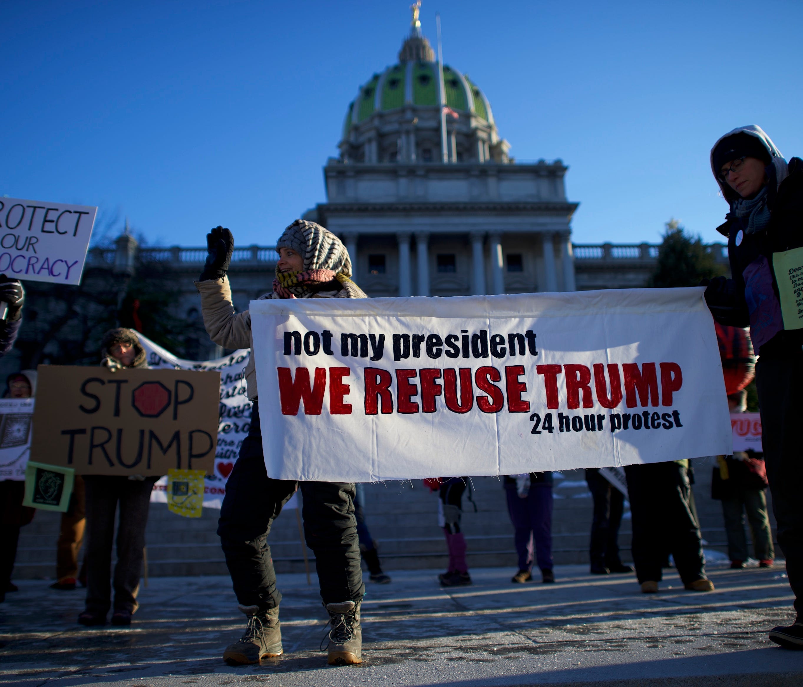 Trump protesters demonstrate outside the Pennsylvania Capitol building before electors arrive to cast their votes on Dec. 19, 2016, in Harrisburg, Pa.