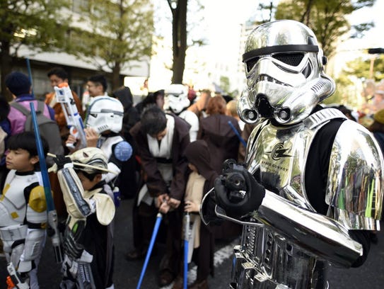 A participant in a Star Wars costume poses before the