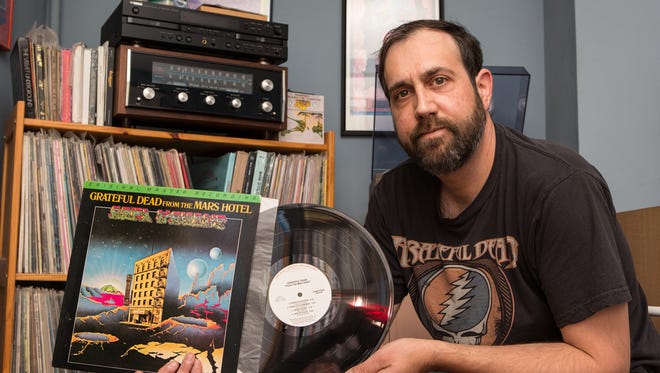 Record collector Mathew Gunby, of Salisbury, holds a copy of the Grateful Dead's "From the Mars Hotel" from his personal collection on Friday, May 27, 2016.