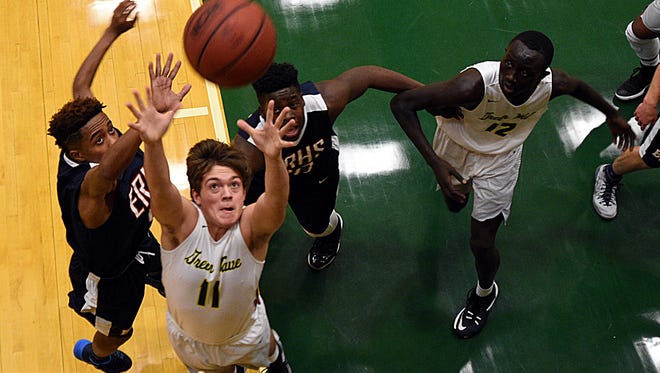 Gallatin High junior Collin Minor elevates to haul in a rebound during first-quarter action against East Ridge.