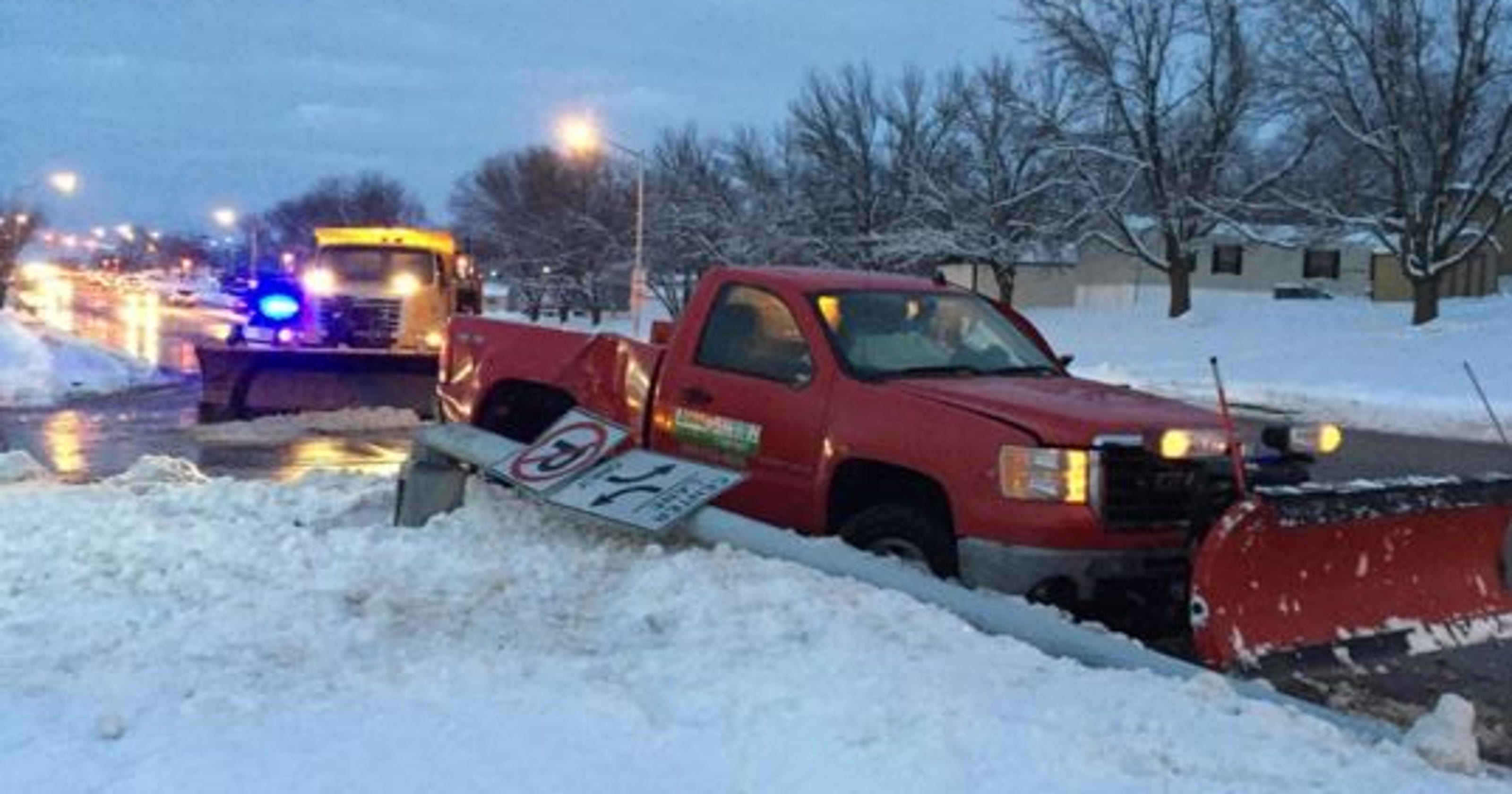 Driver hurt in collision with snow plow that toppled light pole