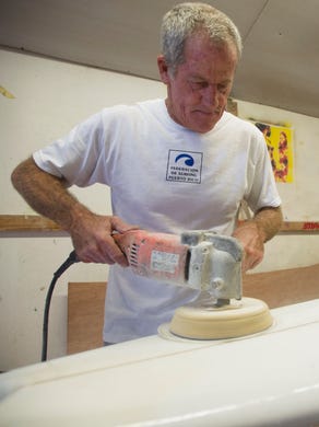 Charles Williams, of Fort Pierce, works on an Impact surfboard Oct. 17, 2017 from his home in Fort Pierce. Williams started building surfboards in the mid-1970s. ÒThatÕs the only thing I know how to do is make surfboards.Ó 