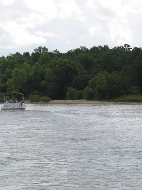 Members of the Chattahoochee Riverkeeper group view a sandbar that blocks water flow into Poloway Cutoff on the Apalachicola River near Blountstown.