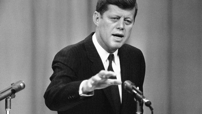 FILE - In this April 12, 1961, file photo, President John F. Kennedy answers a question during his ninth presidential news conference in Washington The conference dealt largely with space exploration and international affairs. A president’s first 100 days can be a tire-squealing roar from the starting line, a triumph of style over substance, a taste of what’s to come or an ambitious plan of action that gets rudely interrupted by world events. (AP Photo/RMB)