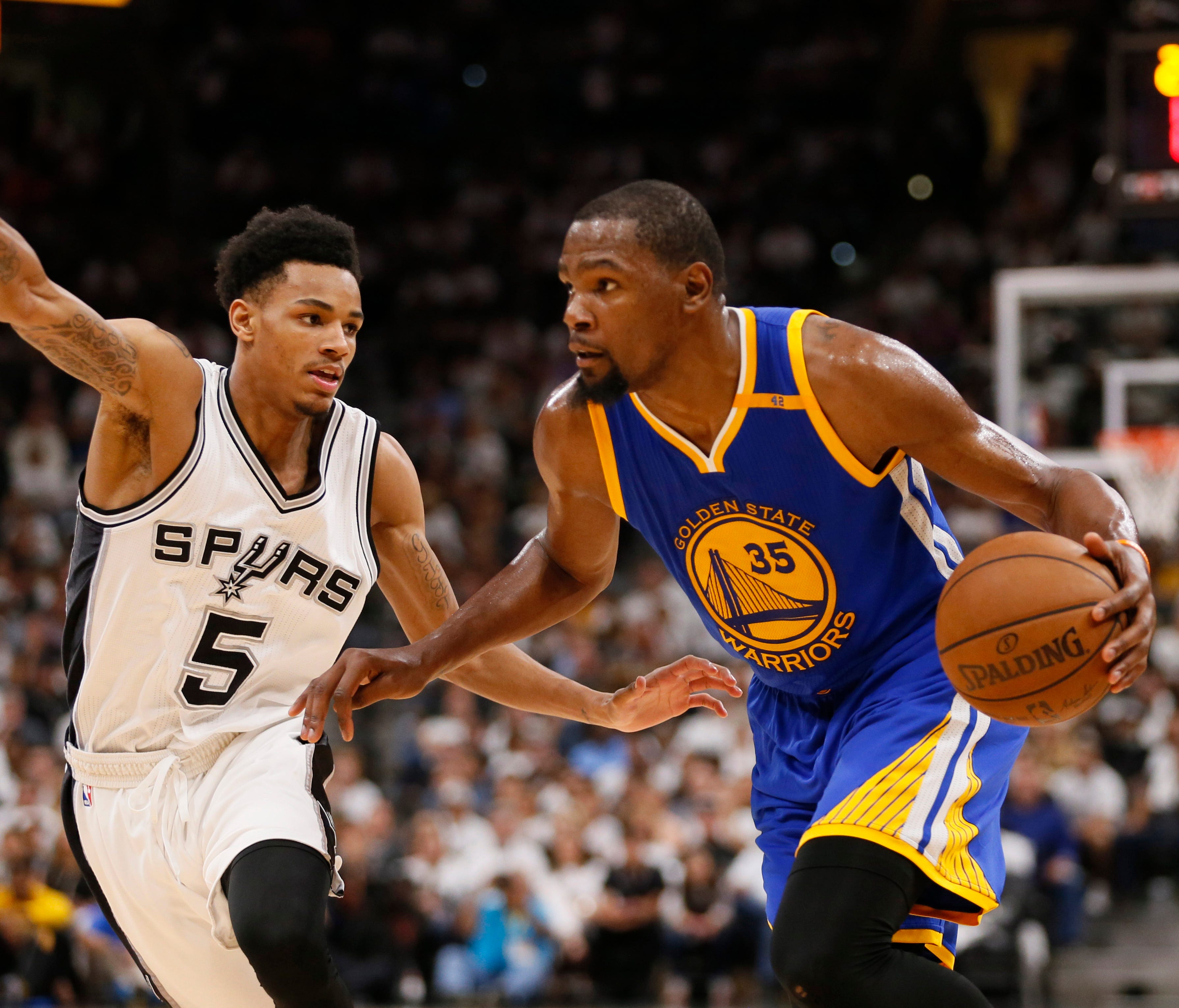 Golden State Warriors small forward Kevin Durant (35) drives to the basket while guarded by San Antonio Spurs point guard Dejounte Murray (5) during the second half in game three of the Western conference finals of the NBA Playoffs.