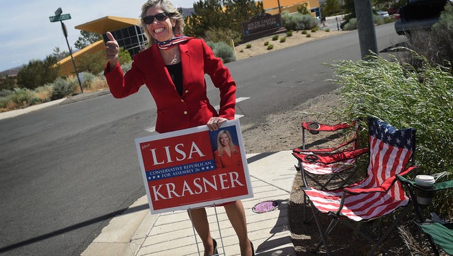 Republican candidate for Assembly District 26 Lisa Krasner greets voters as they approach the South Valleys Library polling location in Reno on Nevada's Primary Election day on June 14, 2016.