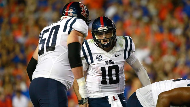 Ole Miss sophomore Sean Rawlings (50) communicates with quarterback Chad Kelly during the team's game last fall at Florida. Rawlings figures to be part of a remade Rebels offensive line this fall.