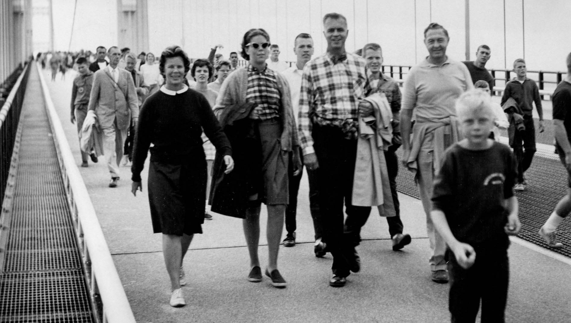 Governor G. Mennen (Soapy) Williams with wife Nancy walk in the first Mackinac bridge walk in late June 1958 during the Bridge's dedication ceremony.