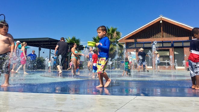 Kids splash in Imagination Fountain at Cascades Park.