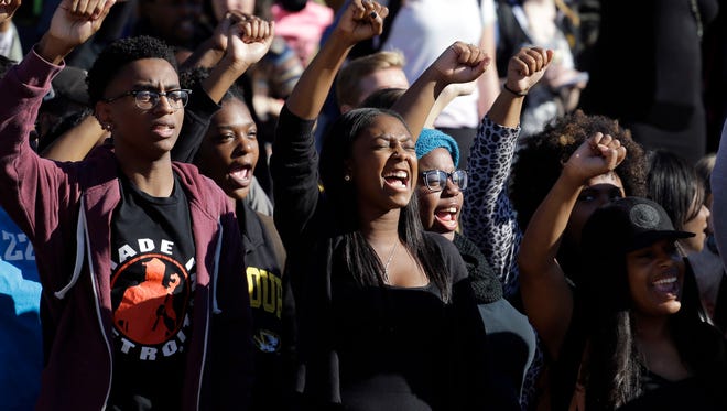 FILE - In this Nov. 9, 2015, file photo, students cheer while listening to members of the black student protest group Concerned Student 1950 speak following the announcement that University of Missouri System President Tim Wolfe would resign at the university in Columbia, Mo. In the ouster of the Missouri’s president, leaders of student groups on other campuses dealing with racial strife see an opening to press their own university administrators for better treatment of black students. (AP Photo/Jeff Roberson, File)