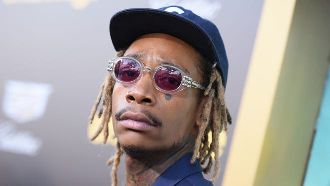 Rapper Wiz Khalifa arrives at the Los Angeles premiere of "Entourage"on June 1, 2015. Two men pleaded guilty, Friday, June 19, to third-degree murder and robbery-related charges in the January 2014 drug-related shooting death of Khalifa’s uncle Imani Porter, 20, in a Pittsburgh-area fast-food restaurant parking lot.