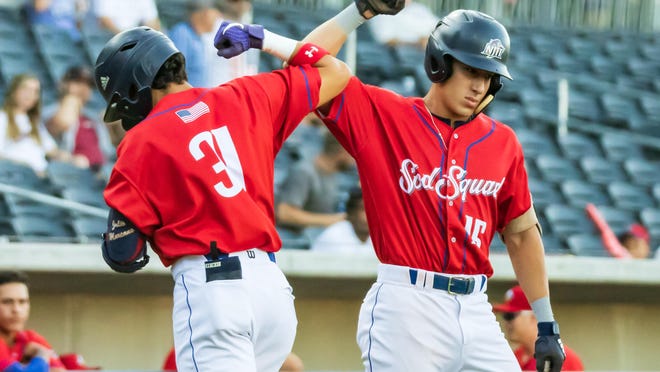 Amarillo Sod Squad twin brothers Julio (left) and David Marcano bump elbows to celebrate Julio's two-run home run Tuesday night against the Texarkana Twins at Hodgetown.