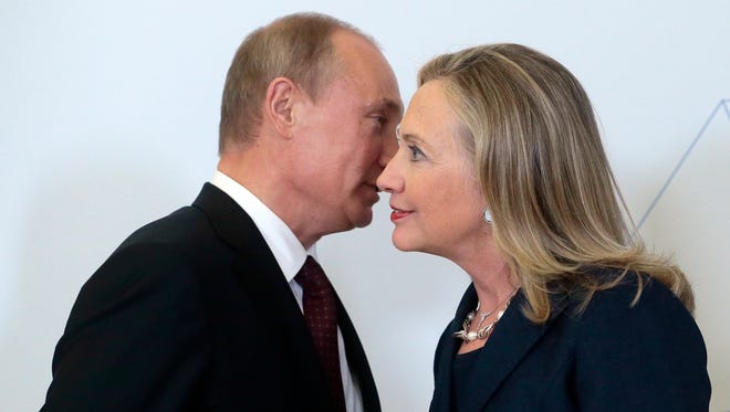 Russian President Vladimir Putin with then-secretary of State Hillary Clinton