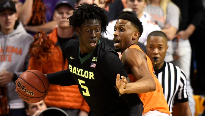 Oklahoma State forward Leyton Hammonds, right, defends against Baylor forward Johnathan Motley during the first half of Wednesday's game. (AP Photo/Brody Schmidt)