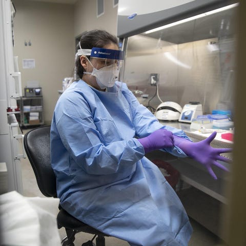 Microbiologist Chelsey Tiger tests samples for vir