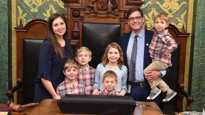 State Rep. Andrew Fink, of Hillsdale, was sworn in Wednesday for his first term as a Michigan state representative. He was joined by his wife, Lauren, and his five children, (from left) Dietrich, Frederick, Evangeline, Van, and Gustav. The 101st Michigan Legislature began session following the swearing-in ceremony.