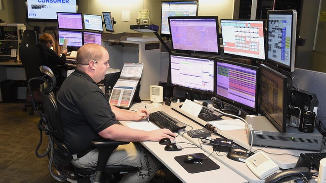 Dispatcher Adam Bolgiano from the Stark County Sheriff's Office takes a call from a Stark County resident in December 2018 in this file photo. Consultants are reaffirming a 2008 recommendation that Stark County use one dispatch center.