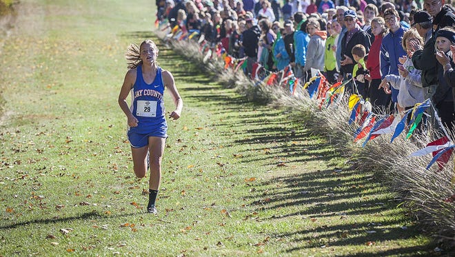 Jay County's Megan Wellman finishes first during the cross country sectional at the Sportsplex in Muncie on Saturday, Oct. 10, 2015.