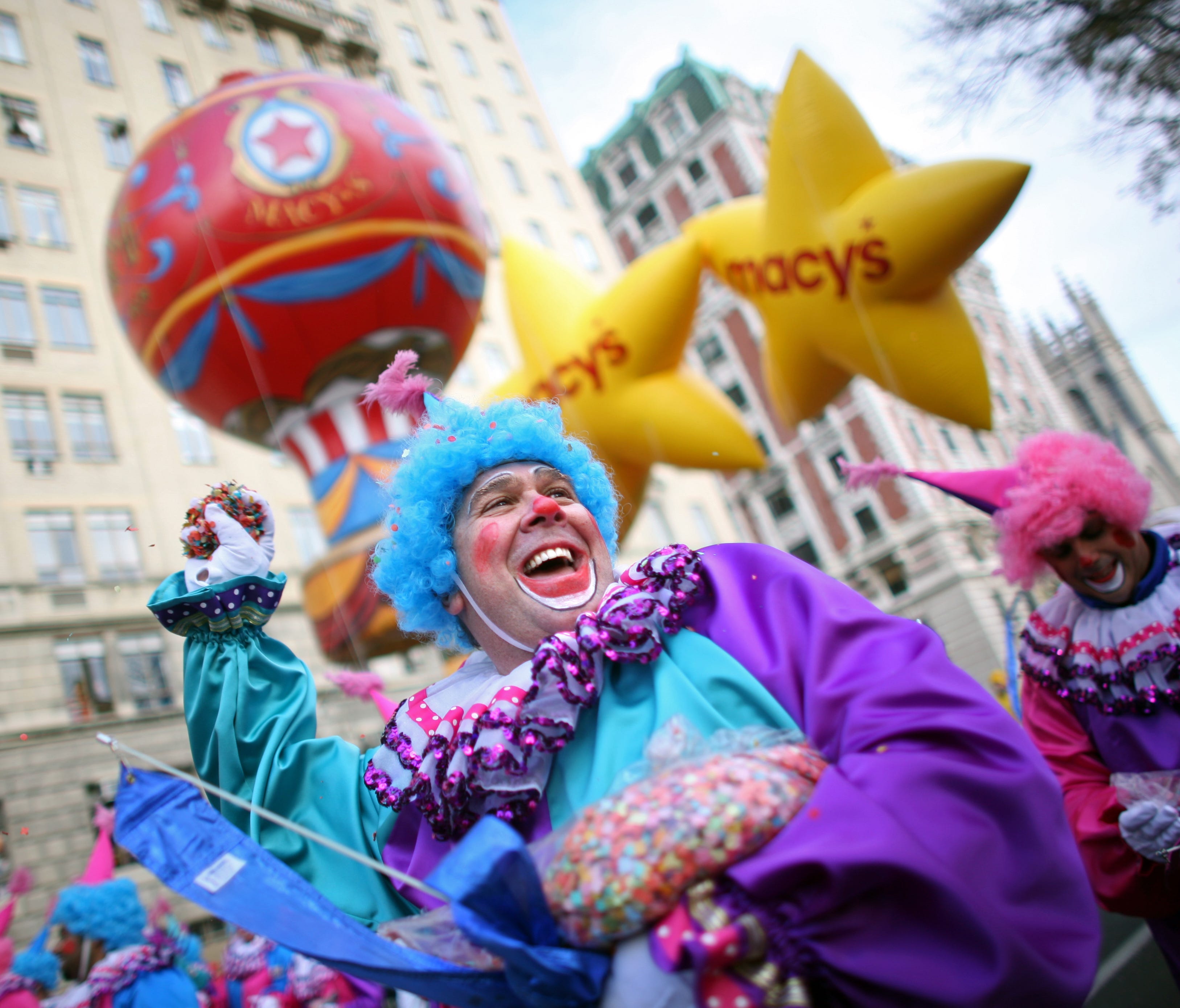 Parade participants throw confetti at the audience in front of the Macy's float at the annual Macy's Thanksgiving Day Parade on November 27, 2008 in New York City. (Photo by Yana Paskova/Getty Images)